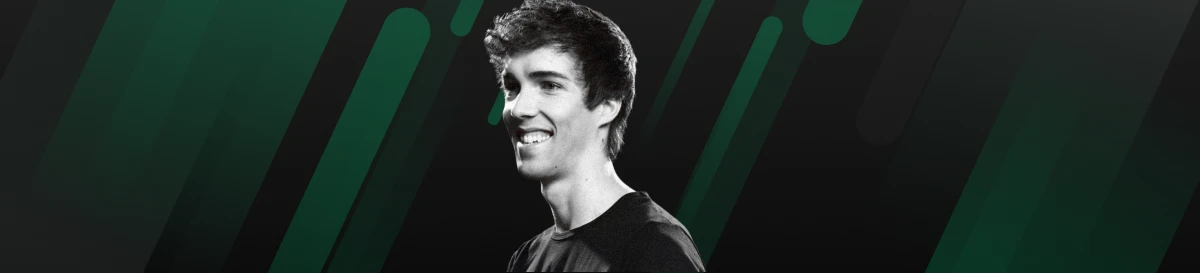 Grubby smiling in a dark esports-themed backdrop