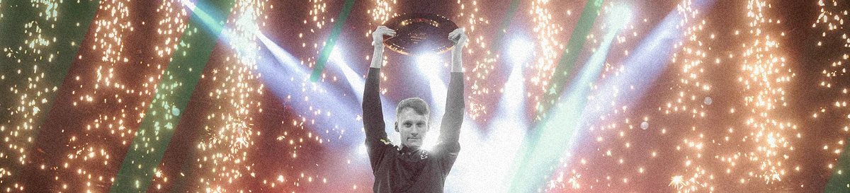Serral celebrates victory on stage with trophy and fireworks in the background